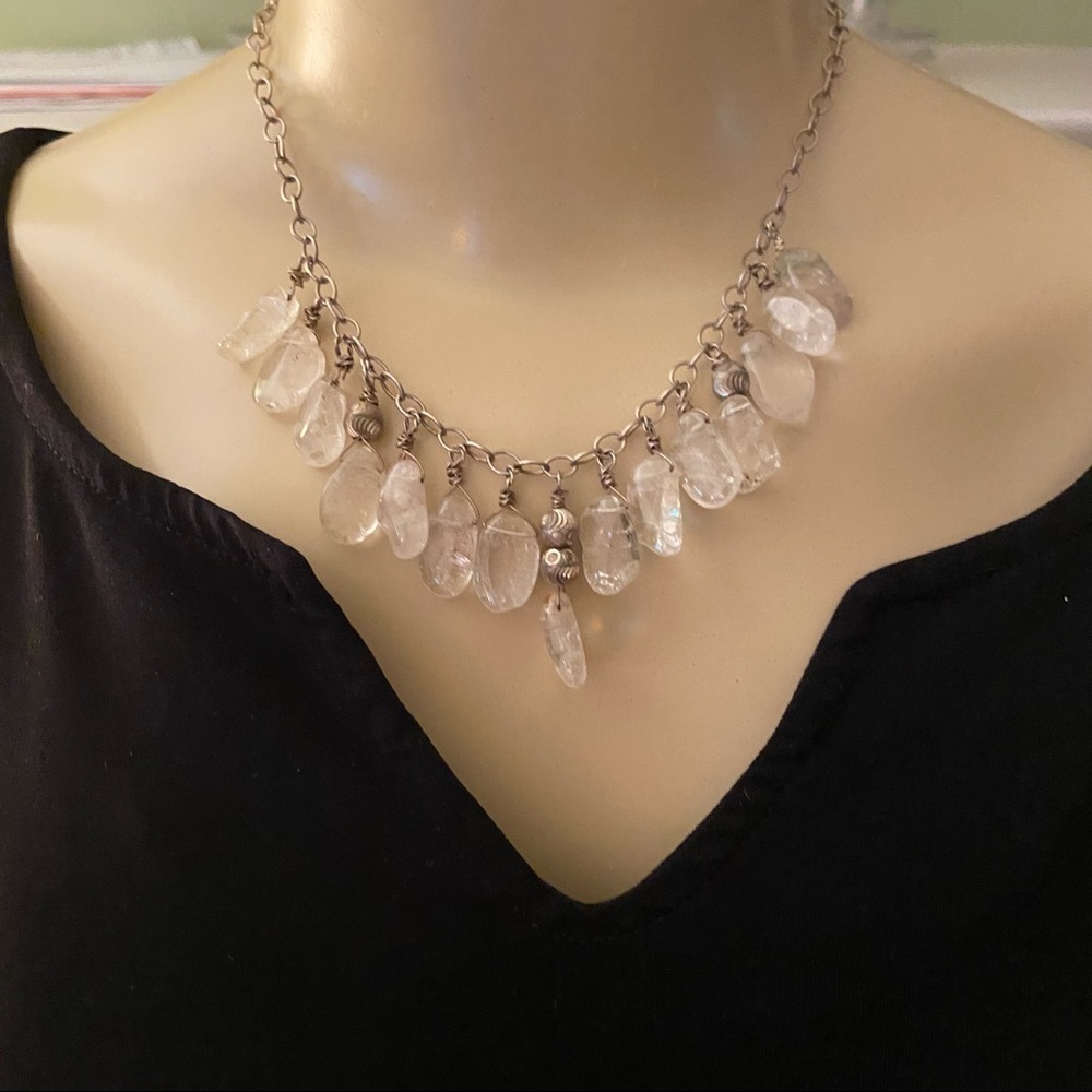 Organic teardrop crystals dangle from carved silver beads along a silver chain.